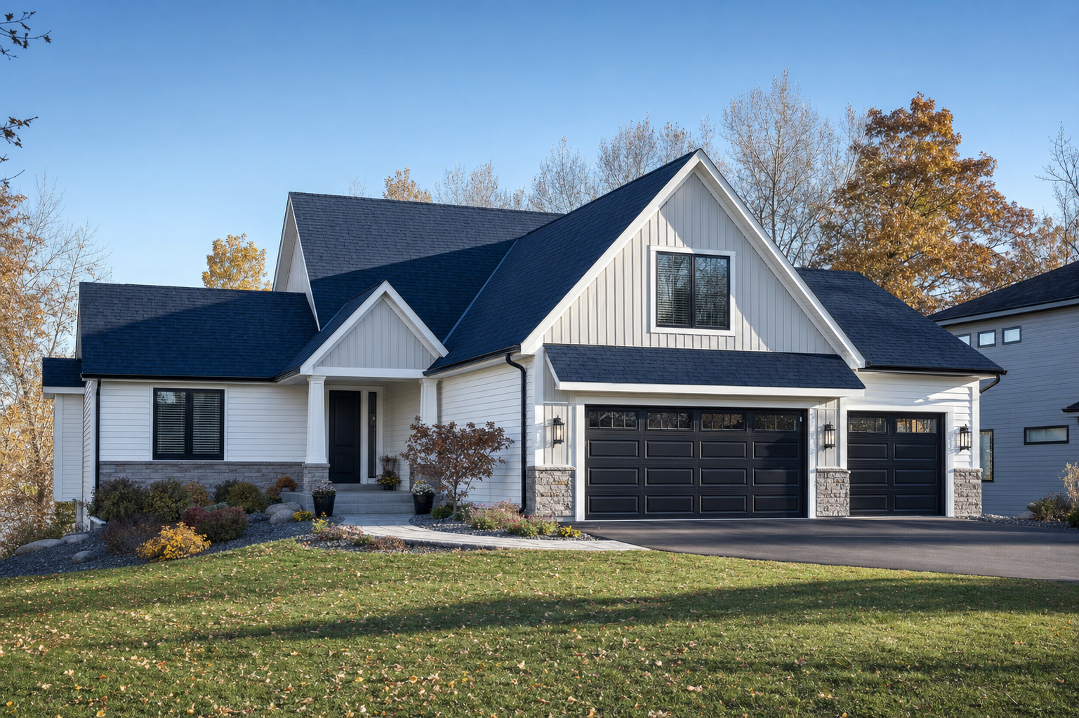 A completed roofing and siding project on a Minnesota home under a clear blue sky